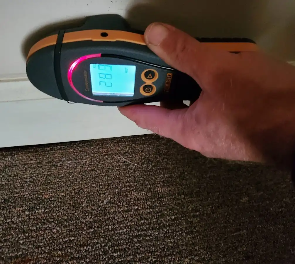 Moisture detection at baseboard during Storm Damage Restoration in De Pere